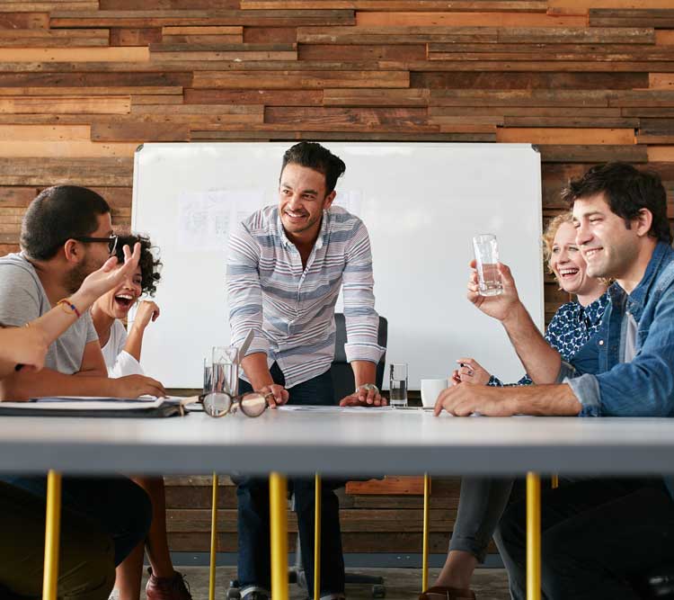 group of happy young people having a business meeting creative people sitting at table